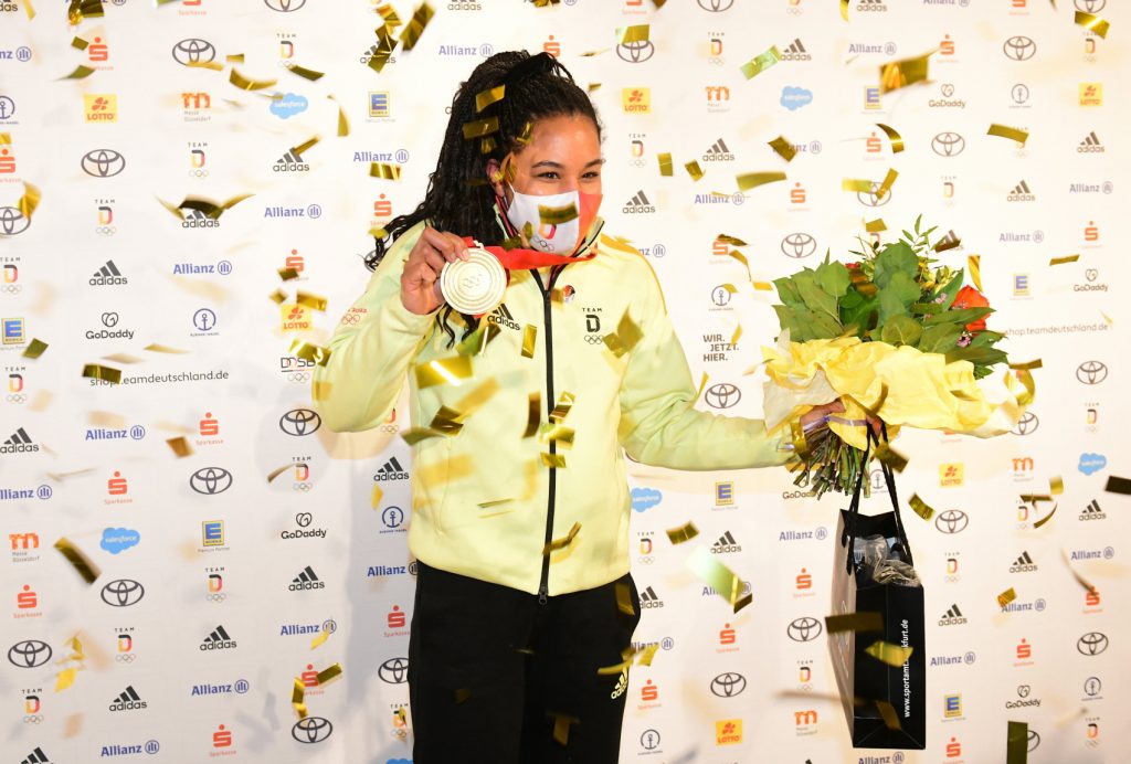Bobsledder Deborah Levi celebrates her gold medal in Beijing 2022. 

